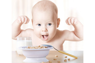 Strong baby eating cereal
